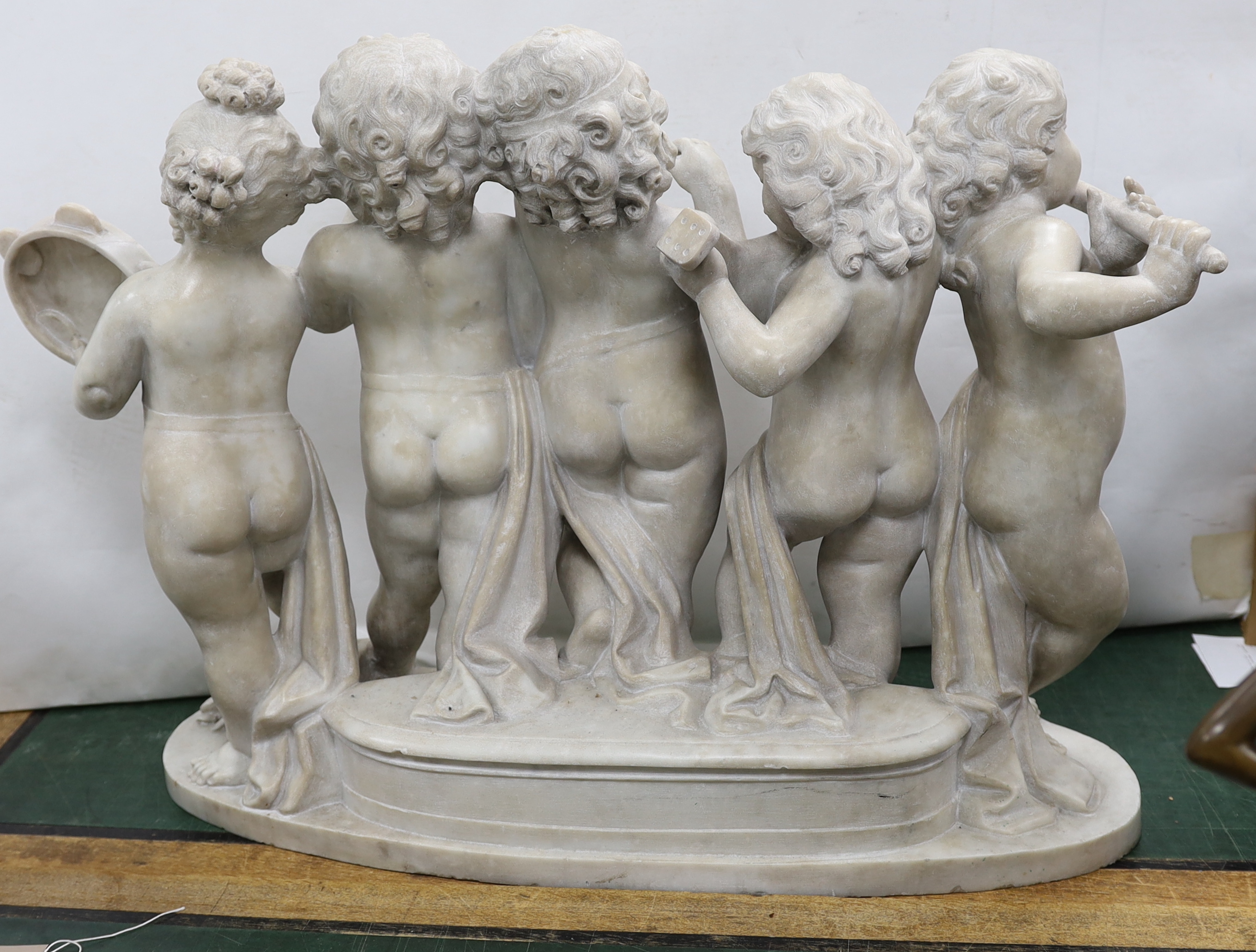 After the Ferdinando Vichi Gallery, an Italian white Carrara marble group 'Musica', 82cm wide, 63cm high, Please note this lot attracts an additional import tax of 5% on the hammer price